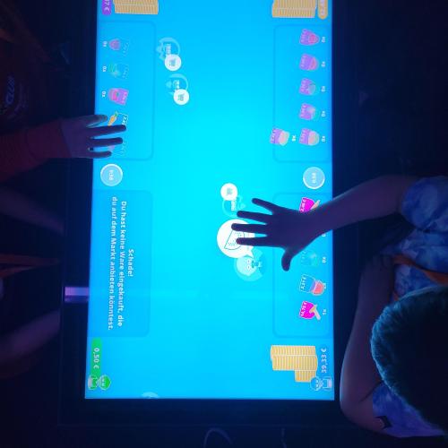 Schüler verkaufen Lebensmittel am Markt im Tablet