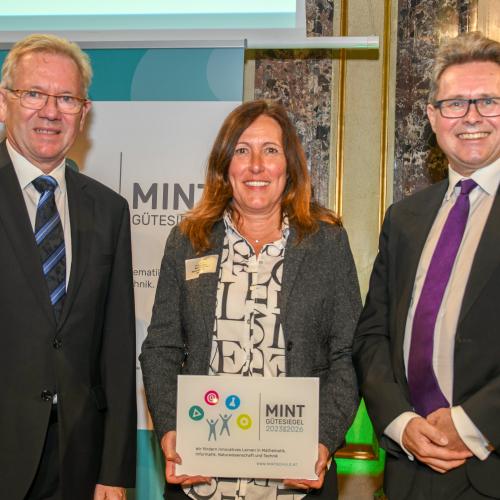 Frau Koch wird die MINT-Urkunde übergeben.