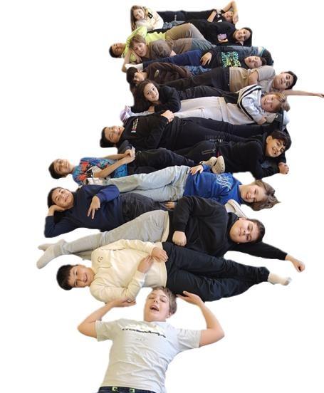 Klassenfoto 1c: Alle Kinder liegen horizontal und ein Schüler tut so als ob er sie heben würde.
